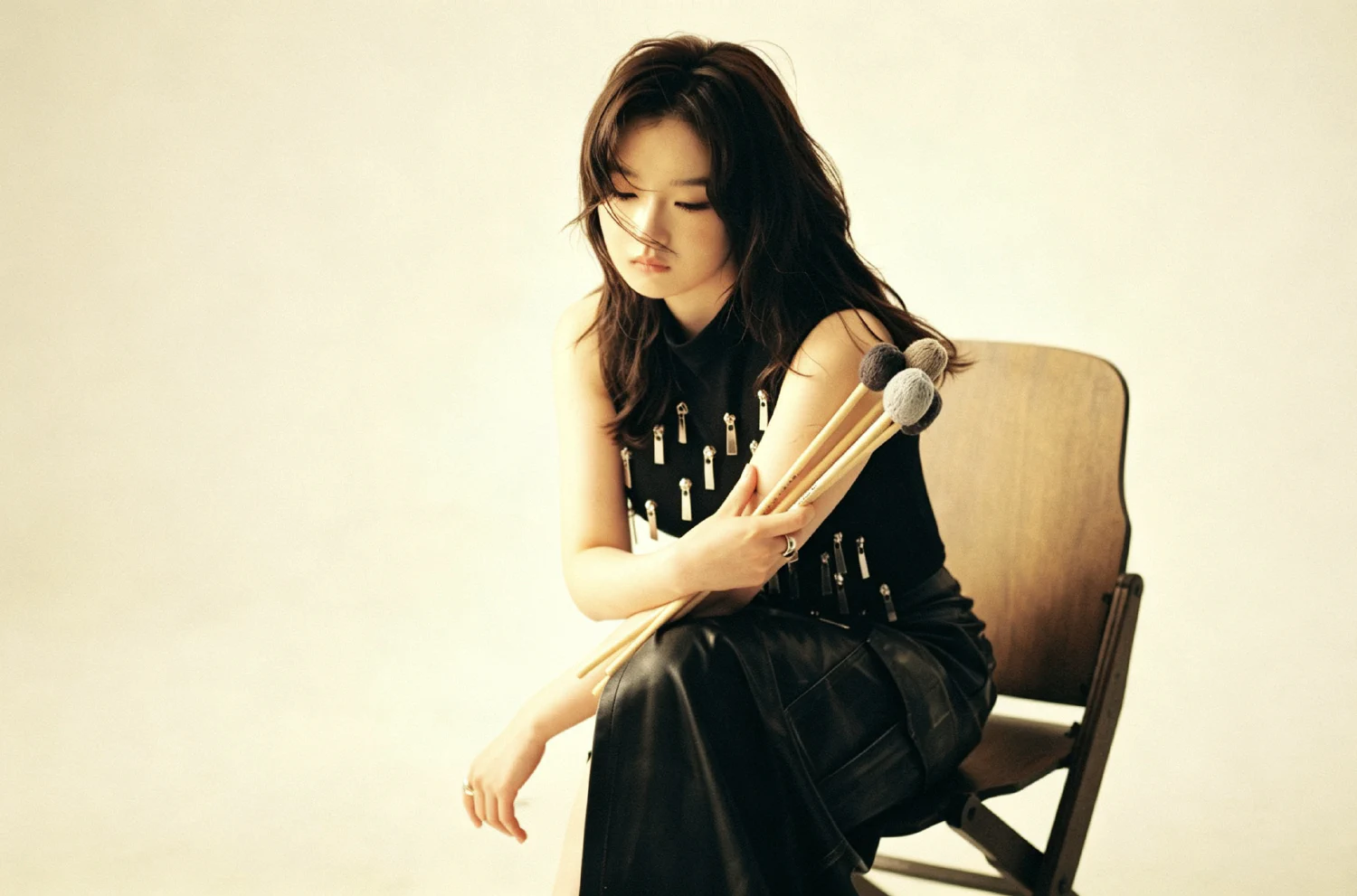 Deqi Mu seated with percussion mallets
